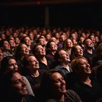 Audience bursting out laughing at comedy show