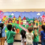 Students working together on a large mural