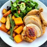 Roast chicken dinner with root vegetables and salad