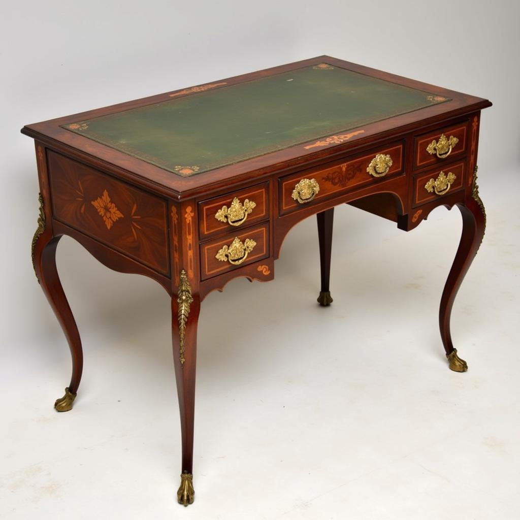 Vintage mahogany writing desk with intricate inlays