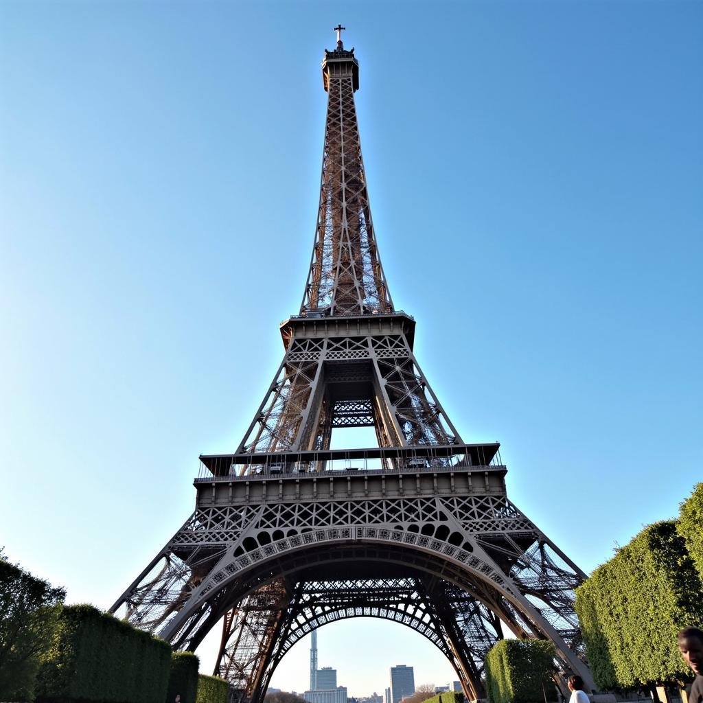 The world-renowned Eiffel Tower in Paris, France, a famous landmark viewed from below during daytime.